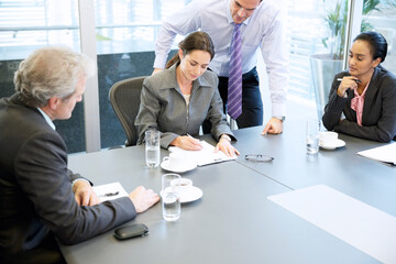 Business people reviewing paperwork in meeting