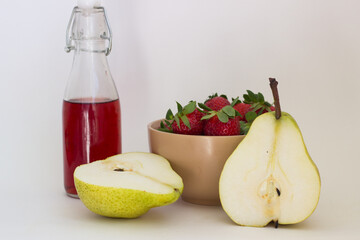 cherry juice pear and strawberry in a plate on a white background