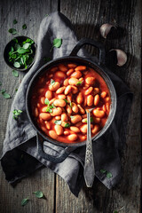 Top view of tasty baked beans with tomatoes and garlic