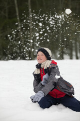 Fototapeta na wymiar Portrait of happy boy enjoying snowball fight