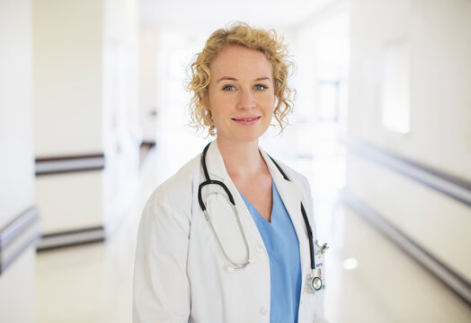 Portrait of smiling doctor in hospital corridor