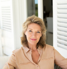 Fototapeta premium Portrait of smiling senior woman on patio