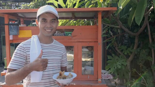 man selling bakso in the carts. indonesia street food vendor. small business entrepreneur