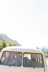 Couple driving camper van on rural road