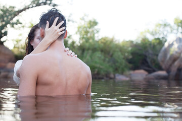 Fototapeta premium Couple hugging in lake