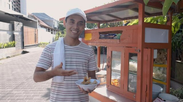 man selling bakso in the carts. indonesia street food vendor. small business entrepreneur