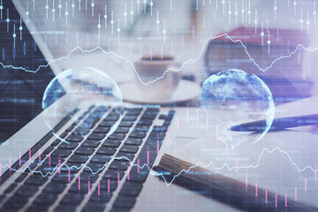 Double exposure of financial chart drawing and desktop with coffee and items on table background. Concept of forex market trading