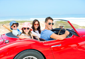 Portrait of smiling family in convertible at beach