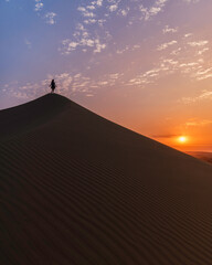 girl in the top of a mountain in the middle of the desert