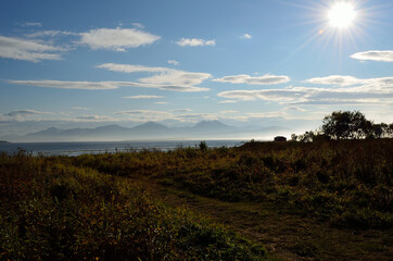 mountain,sunshine,seafog and cabins near fjord in autumn