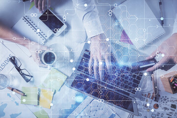 Double exposure of man's hands typing over computer keyboard and data theme hologram drawing. Top view. Technology concept.