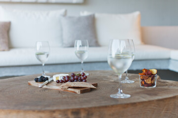 Wine and cheese on wooden coffee table