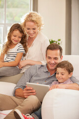 Obraz premium Family using digital tablet on sofa