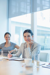 Businesswoman smiling in conference room