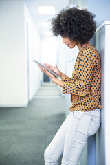 Businesswoman using digital tablet in office - obrazy, fototapety, plakaty