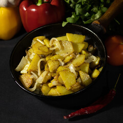 fried potatoes with onions in a pan.