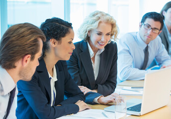 Fototapeta premium Business people using laptop in meeting