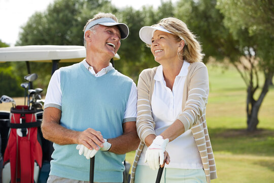Senior couple laughing on golf course