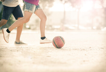 Fototapeta premium Children playing with soccer ball in sand
