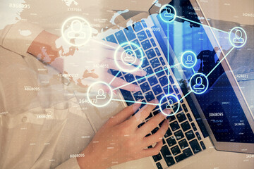 Double exposure of woman hands working on computer and social network theme hologram drawing. Top View. People connection concept.