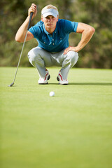 Man preparing to putt on golf course