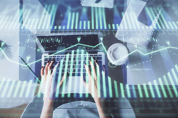 Double exposure of woman hands working on computer and data theme hologram drawing. Top View. Technology concept.