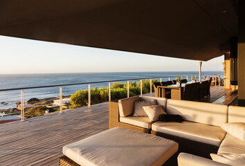 Sofa and table on luxury patio overlooking ocean