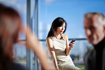 Businesswoman using cell phone in office