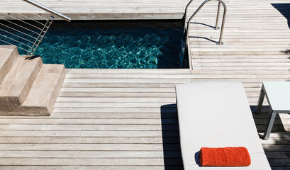 Pool and wooden deck of modern house