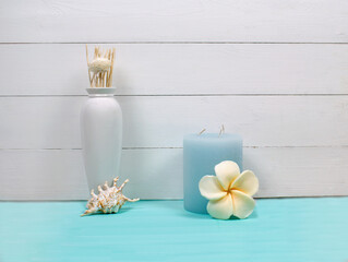 Interior decoration of a house, dry flowers, blue candle, sea shell, handmade soap and white vase on white wood and mint background. Modern interior. Minimalism style.