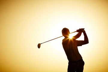 Foto op Canvas Silhouette of man swinging golf club © Chris Ryan/KOTO