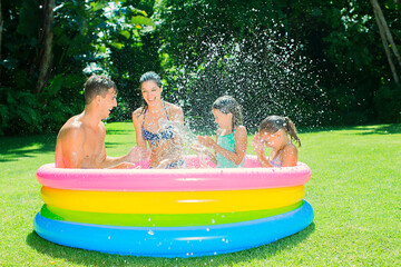 Family playing together in wading pool