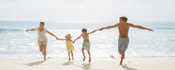 Family running together on beach