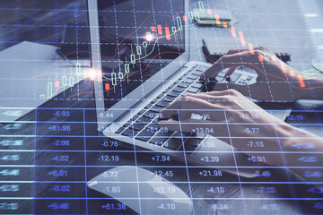 Double exposure of woman hands typing on computer and forex chart hologram drawing. Stock market invest concept.