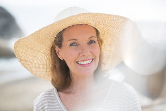 Older woman wearing straw hat on beach