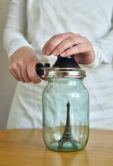 Fototapeta na wymiar Eiffel Tower souvenir in a glass jar
