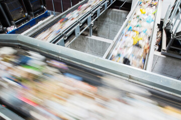 Blurred view of conveyor belts in recycling center - obrazy, fototapety, plakaty