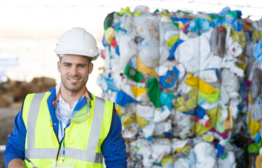 Worker smiling in recycling center