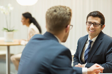 Businessmen talking in office