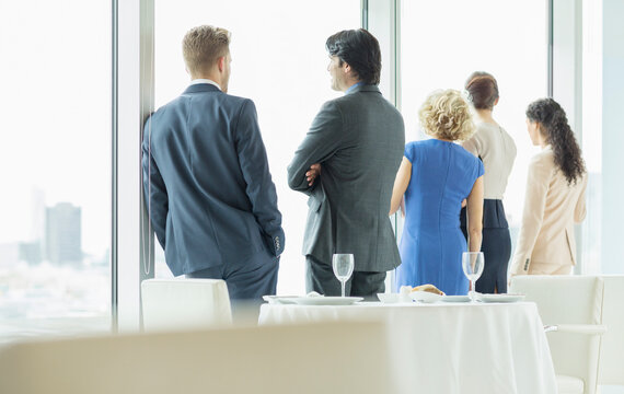 Business People Looking Out Window In Restaurant