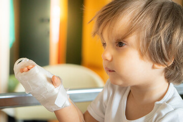 Little girl with saline intravenous on hand in hospital