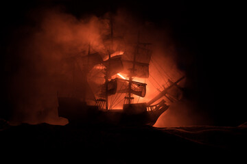Black silhouette of the pirate ship in night