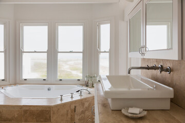 Fototapeta na wymiar Sink and Jacuzzi tub in luxury master bathroom