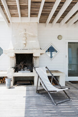 Deck chair and fireplace on patio