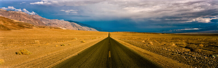 Fototapeta na wymiar Rural road in desert landscape