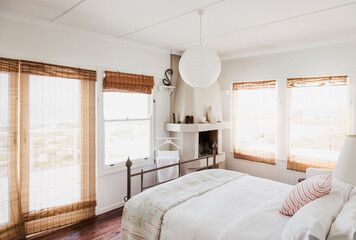 Reed curtains in white bedroom