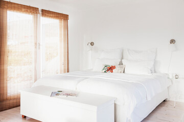 Fototapeta na wymiar Bed and bench in white bedroom