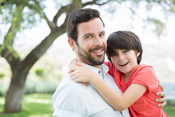 Obraz premium Father and son smiling outdoors