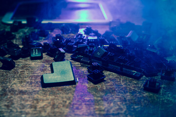 Hammer on computer keyboard with damaged keys