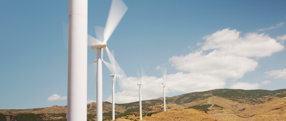 Wind turbines spinning in rural landscape © Martin Barraud/KOTO
